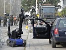 Der Kampfmittelbeseitigungs-Roboter "Theodor" durchsucht ein Auto. (Bild öffnet sich in einem neuen Fenster)