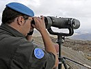 An Austrian Peacekeeper observing the area of separation. (Image opens in new window)