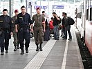 Police and servicemen patrolling the train station in Salzburg.