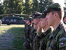 Czech Soldiers stand to attention in front of a "Black Hawk" helicopter. (Image opens in new window)