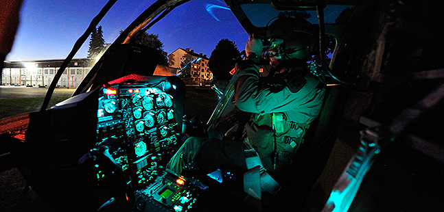 A pilot sits in the cockpit.