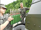 Soldaten der Geschützbedienung laden einen Ladestreifen mit 35mm-Leuchtsprengbrand-granatpatronen.