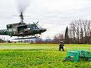 Befestigen der Außenlast in Netzen am Hubschrauber Agusta Bell 212.