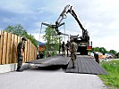 Die ersten Teile werden vom Transportfahrzeug gehoben.