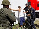 Ein festgenommener Attentäter wird von der Polizei durchsucht. (Bild öffnet sich in einem neuen Fenster)