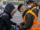 Diese Frau erhält ein Armband. (Bild öffnet sich in einem neuen Fenster)