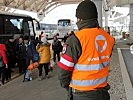 Ein Soldat mit Flüchtlingen. (Bild öffnet sich in einem neuen Fenster)
