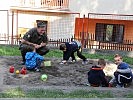 Ein Soldat mit Kindern im Sandkasten. (Bild öffnet sich in einem neuen Fenster)