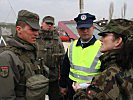 Zusammenarbeit: Österreichische Soldaten mit Polizist und Schweizerin. (Bild öffnet sich in einem neuen Fenster)