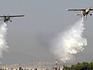 Two of the PC-6 water-bombing planes in action. (Image opens in new window)