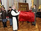 Prälat Wiedermann und Oberstleutnant Gaugusch enthüllen die Ehrenstuckmeistertafel.