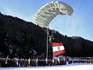 Die Bundesdienstflagge wird durch einen Fallschirmspringer überbracht.