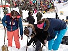 Besucher üben das Suchen von Lawinenopfern.