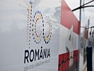 Das Logo zum 100-jährigen Jubiläum von Rumänien mit der Österreichfahne.