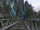 Zwei Mobilkräne hoben die Brücke an, bevor sie in Teilen auseinandergeschraubt werden konnte.