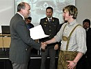 Brigadier Rupert Stadlhofer (l.) übergibt das Lehrabschlusszeugnis.